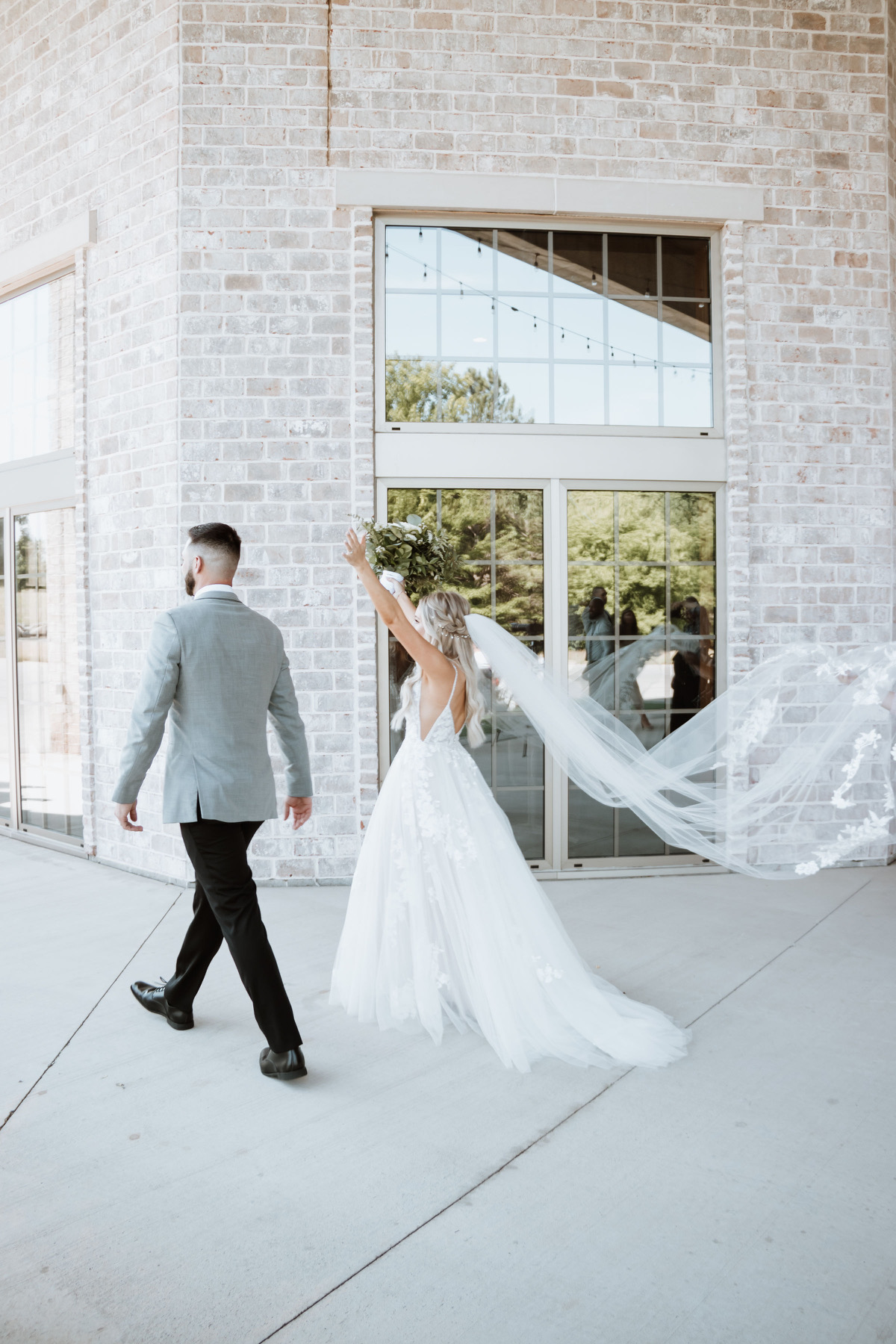 bride and groom walking outside clubhouse